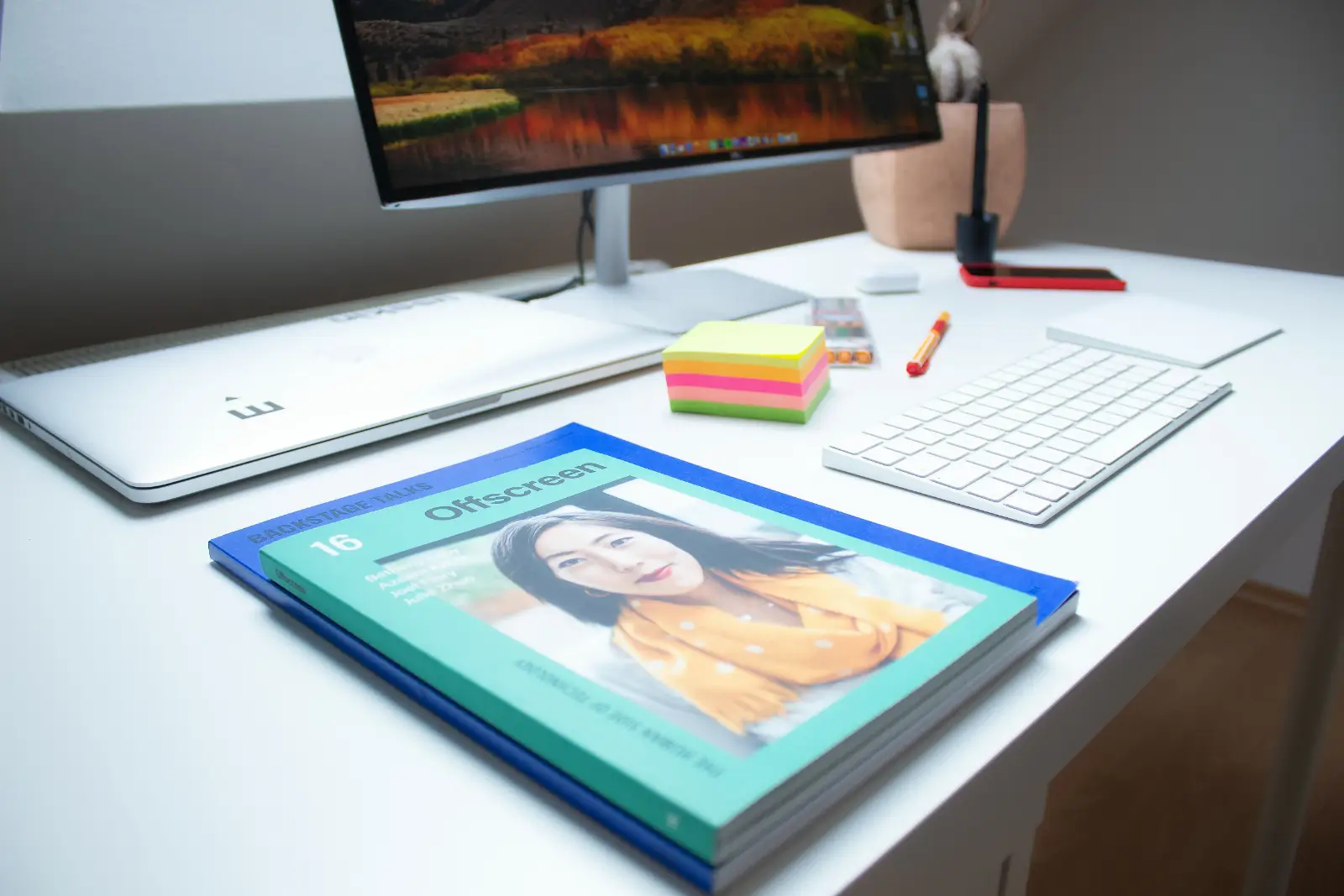 A green and blue books on a desk