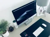 Turned on silver imac on white desk